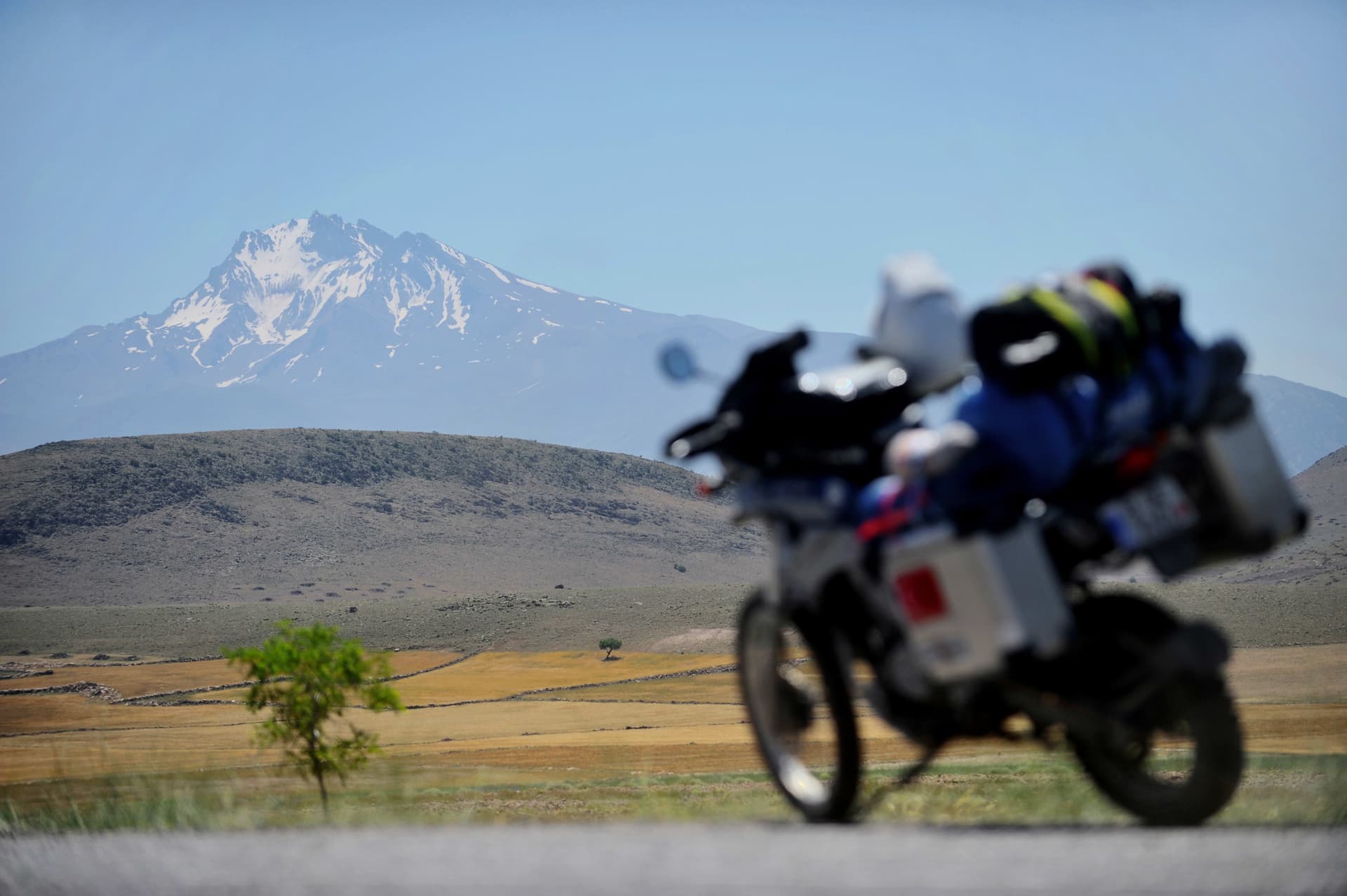 Expansive landscape with Mount Ararat rising beyond a remote journey at golden light